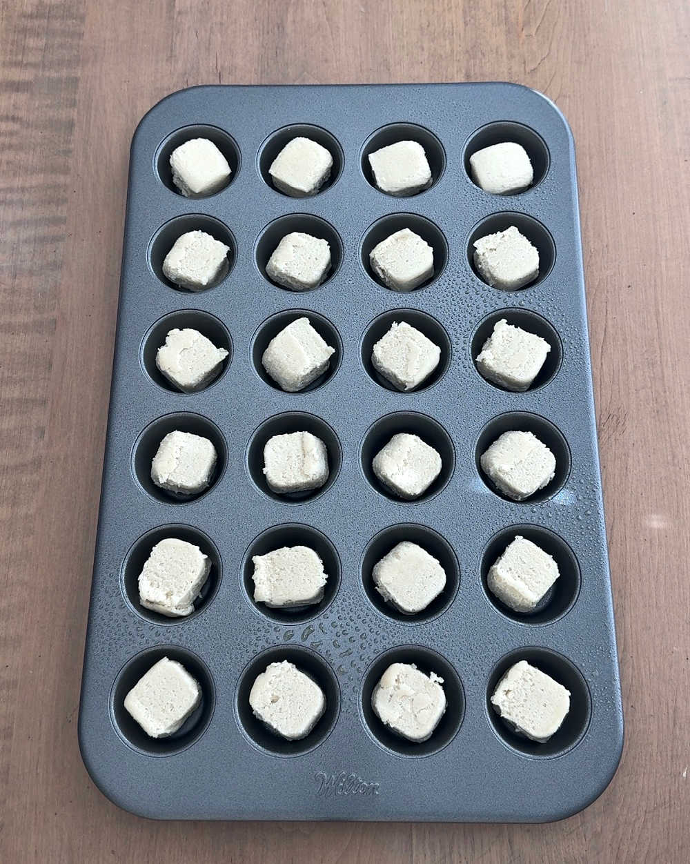 mini muffin tin filled with cookie dough.