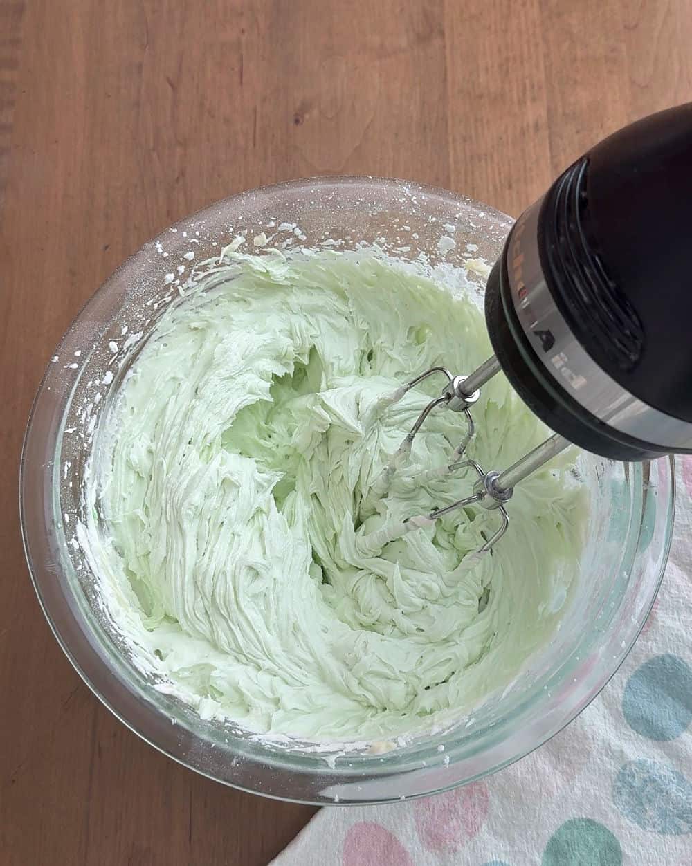 green buttercream frosting in mixing bowl.