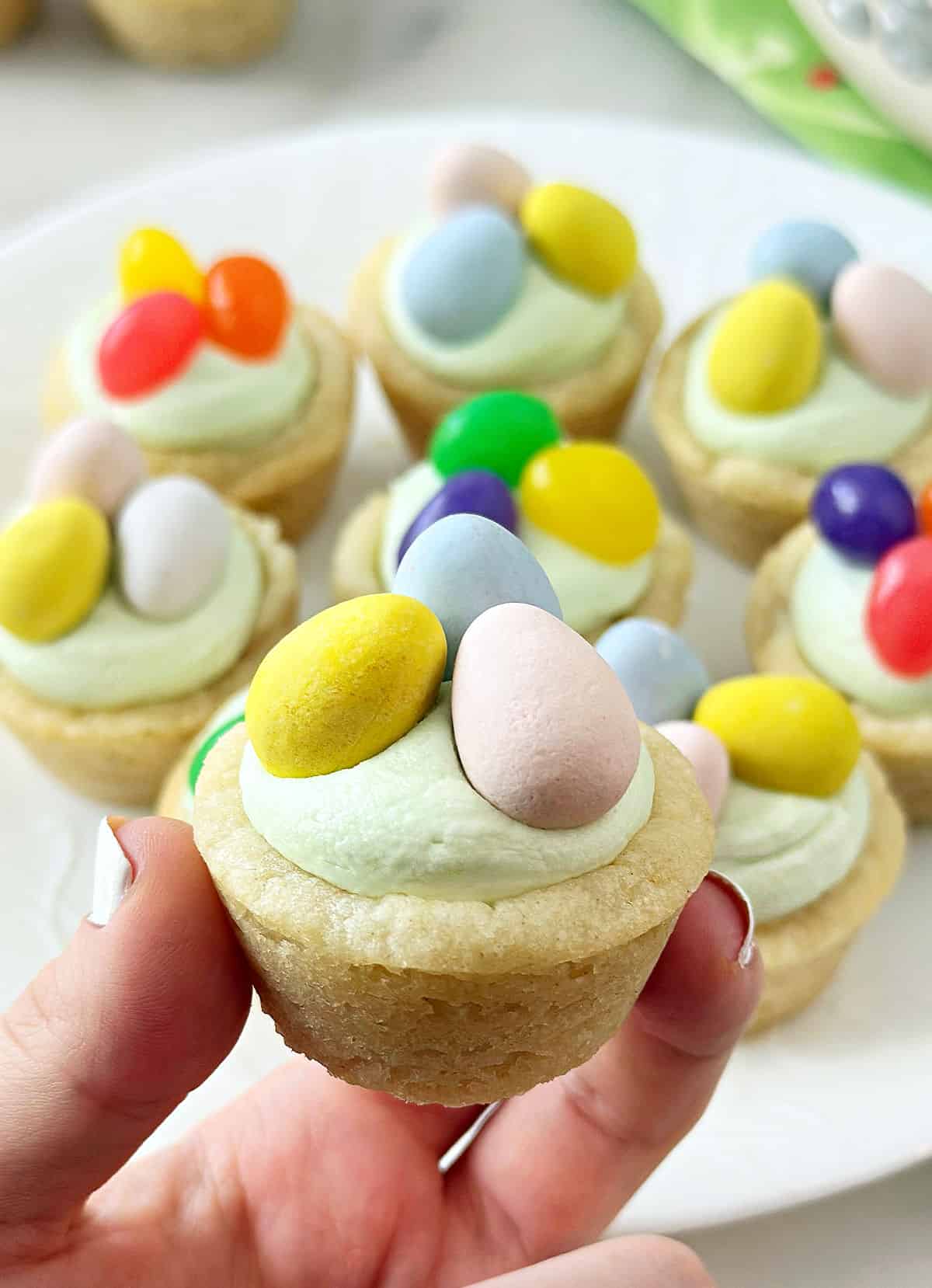 Easter basket sugar cookie cups in hand.