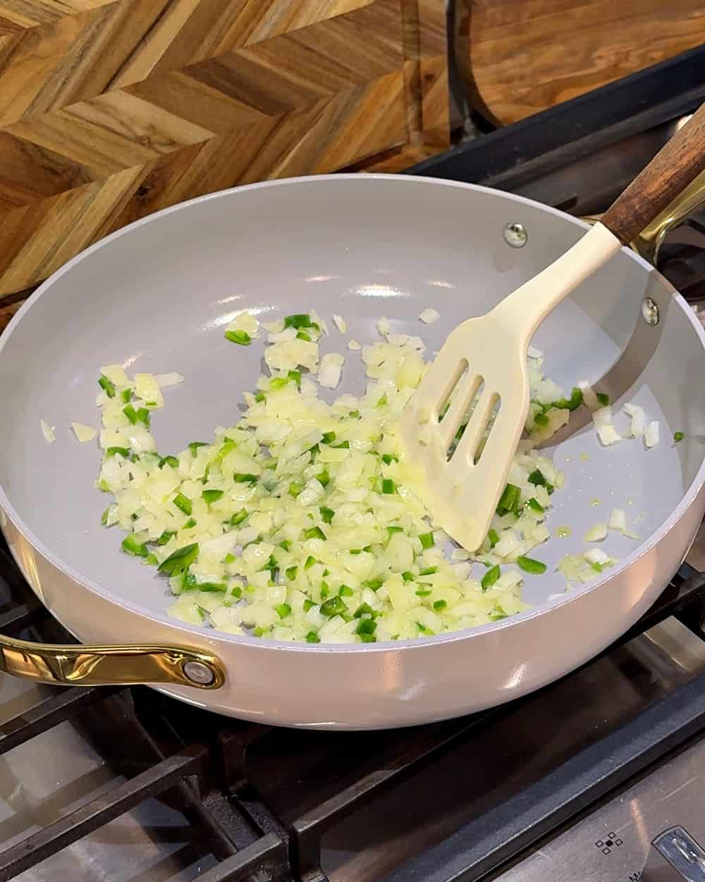 cooking onion and pepper in skillet.