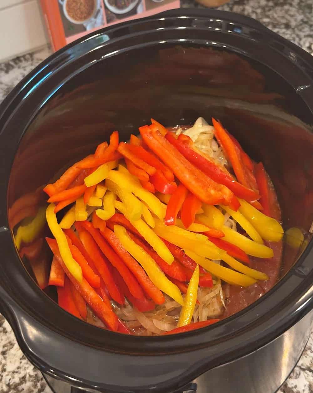 placing pepper strips over onions.