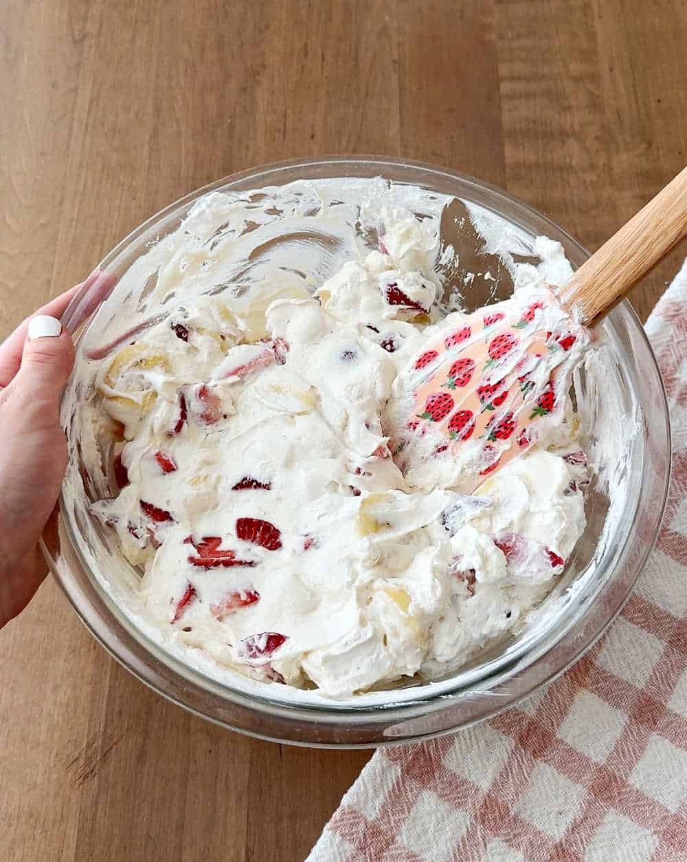 folding ingredients together in bowl.