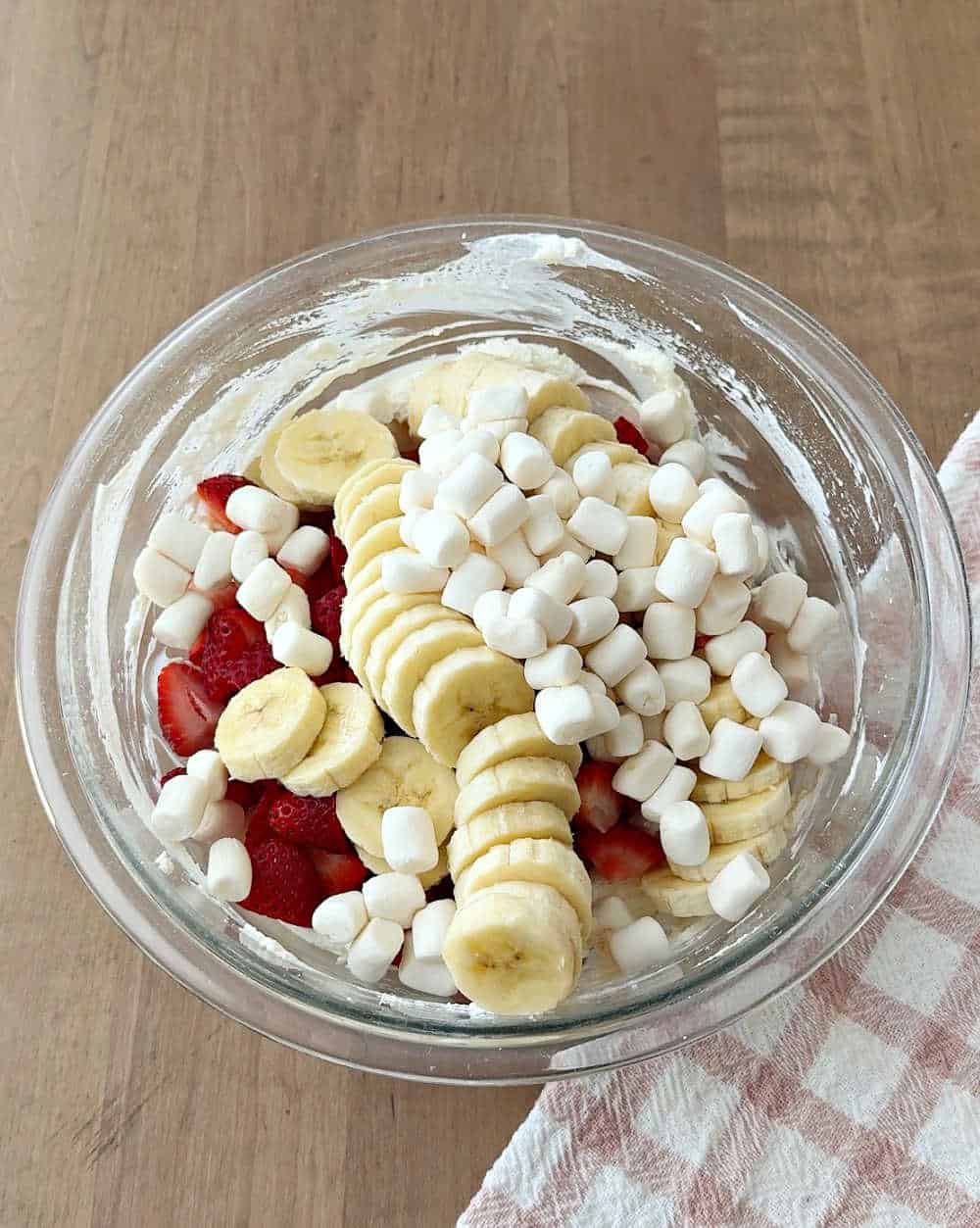 adding fruit and marshmallows.