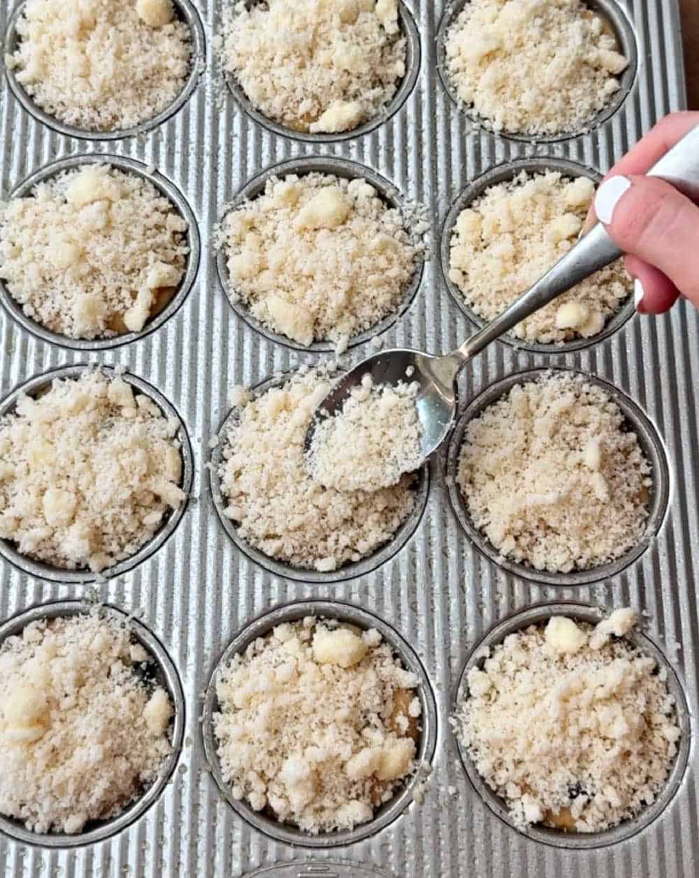 topping muffins with crumble.