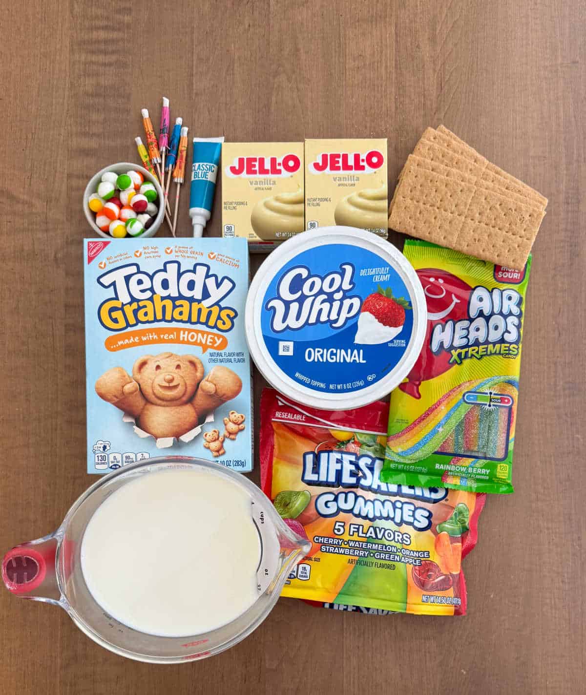 vanilla pudding mix, cool whip, milk, graham crackers, candy and decorations.