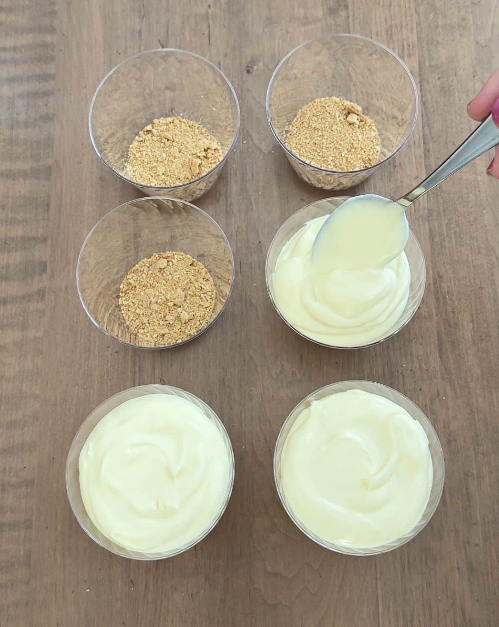 layering dessert in plastic cups.