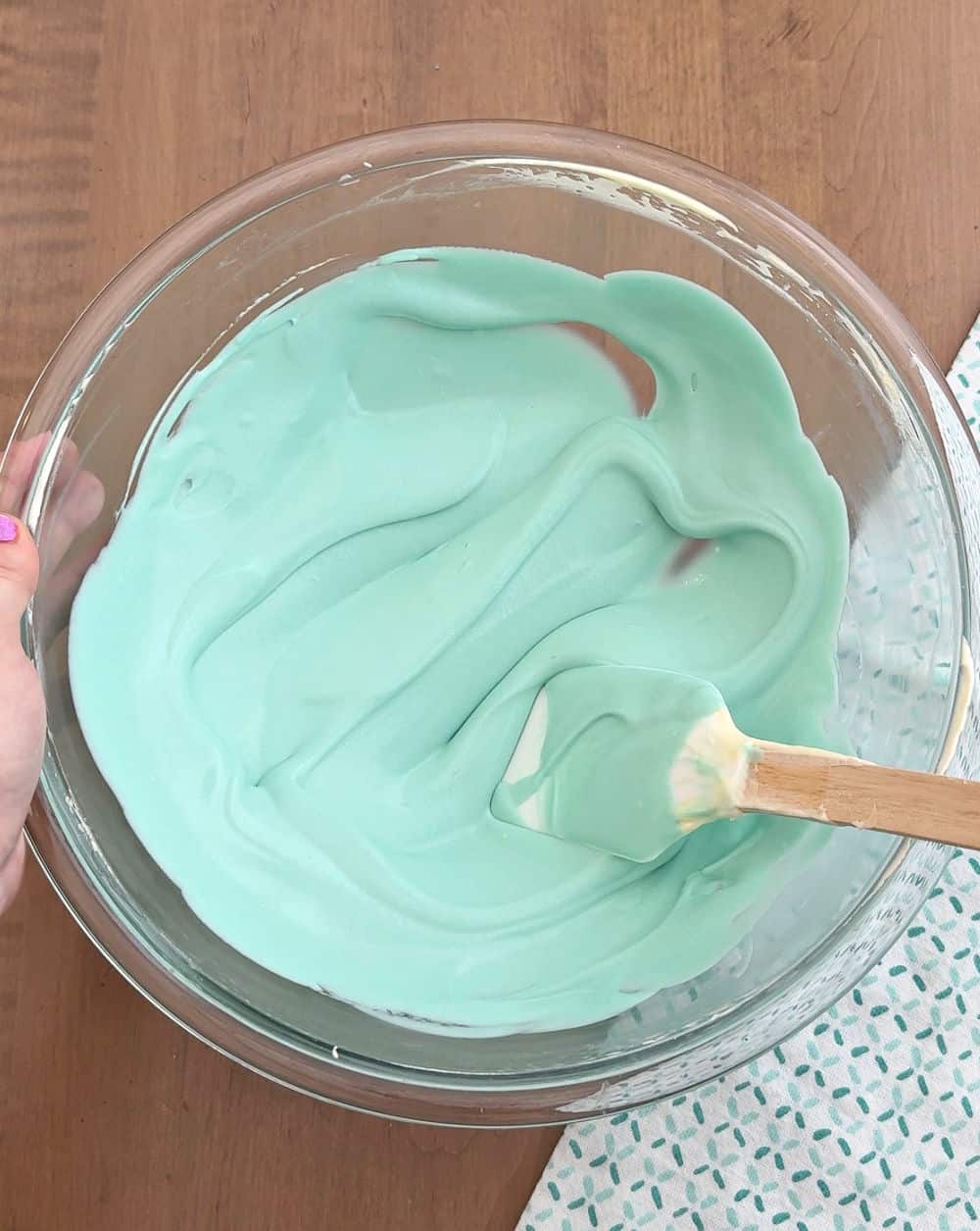 mixing blue pudding in bowl for water.