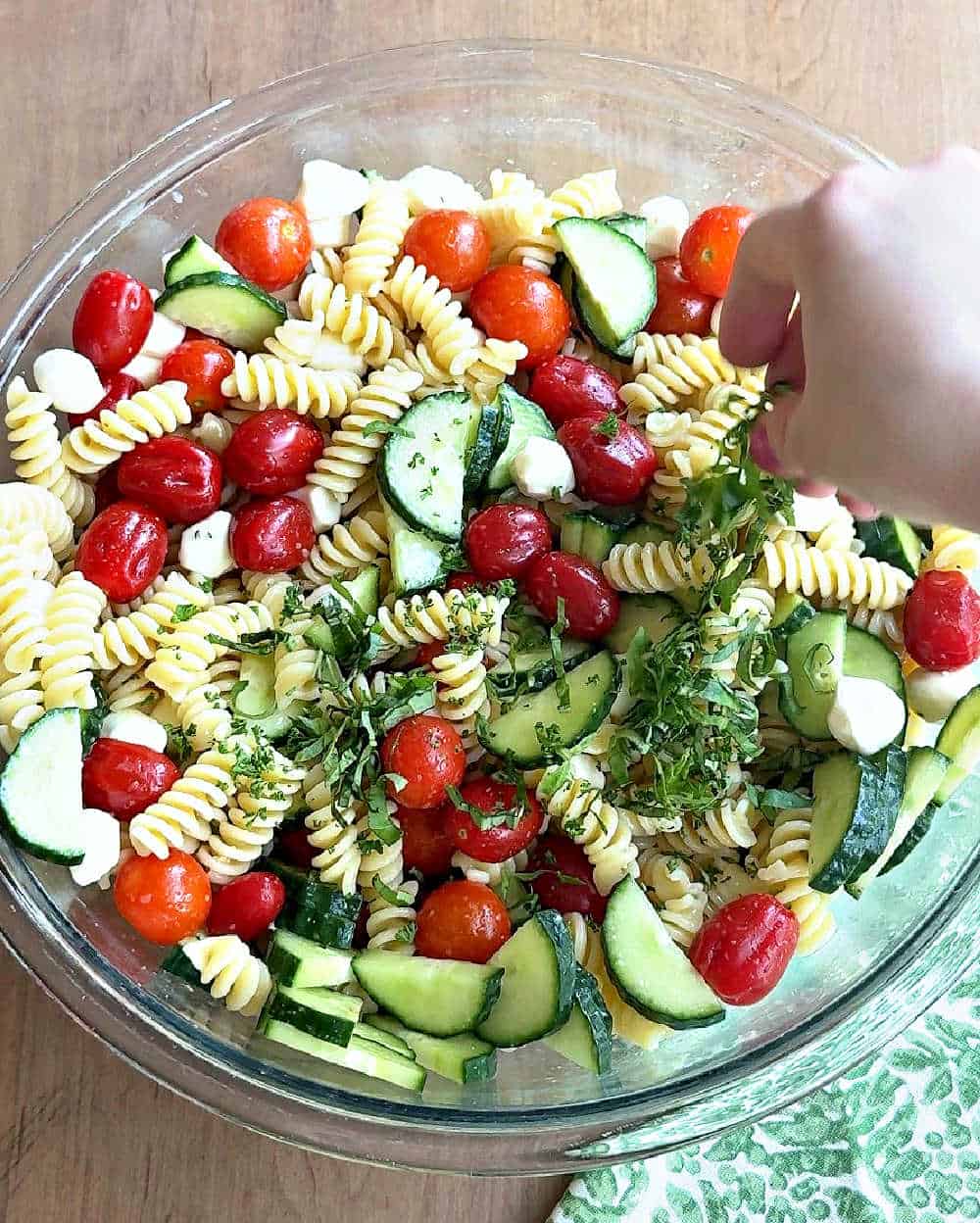 adding fresh herbs to salad.