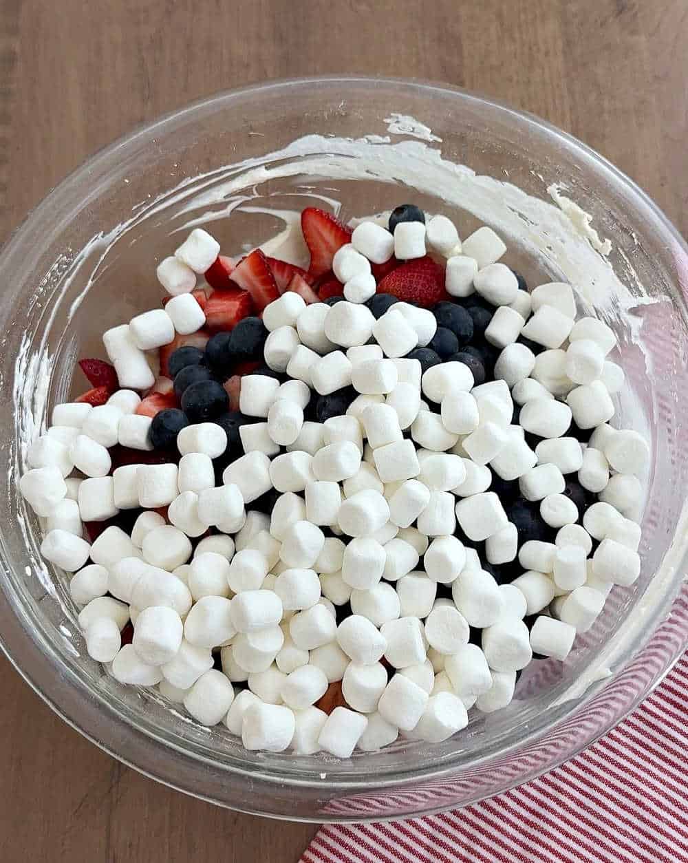 adding fruit and marshmallows.