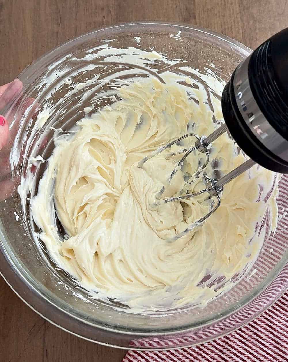 mixing cream cheese in mixing bowl.