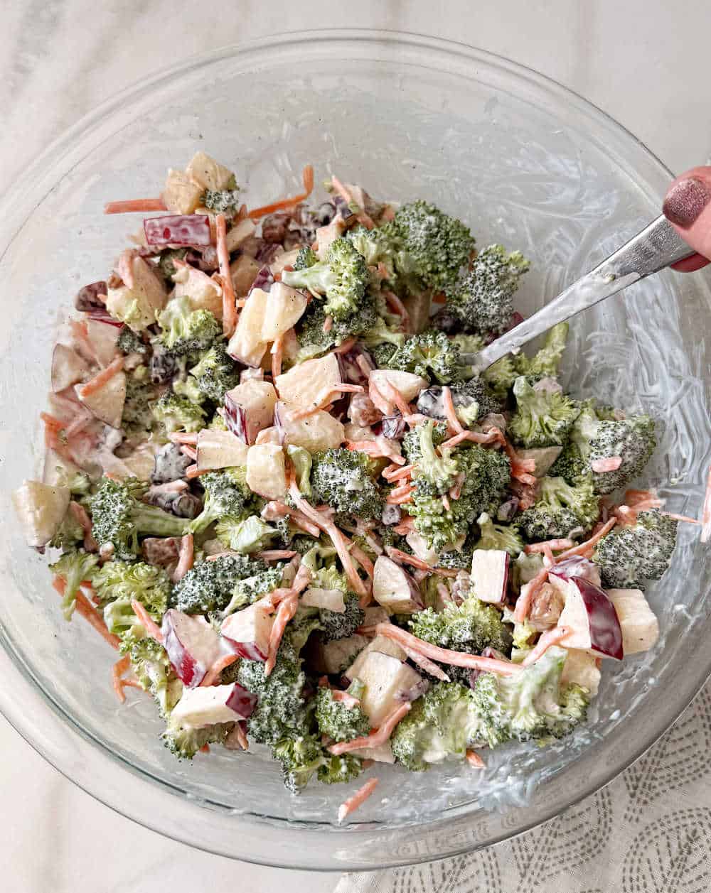 tossing salad with dressing.