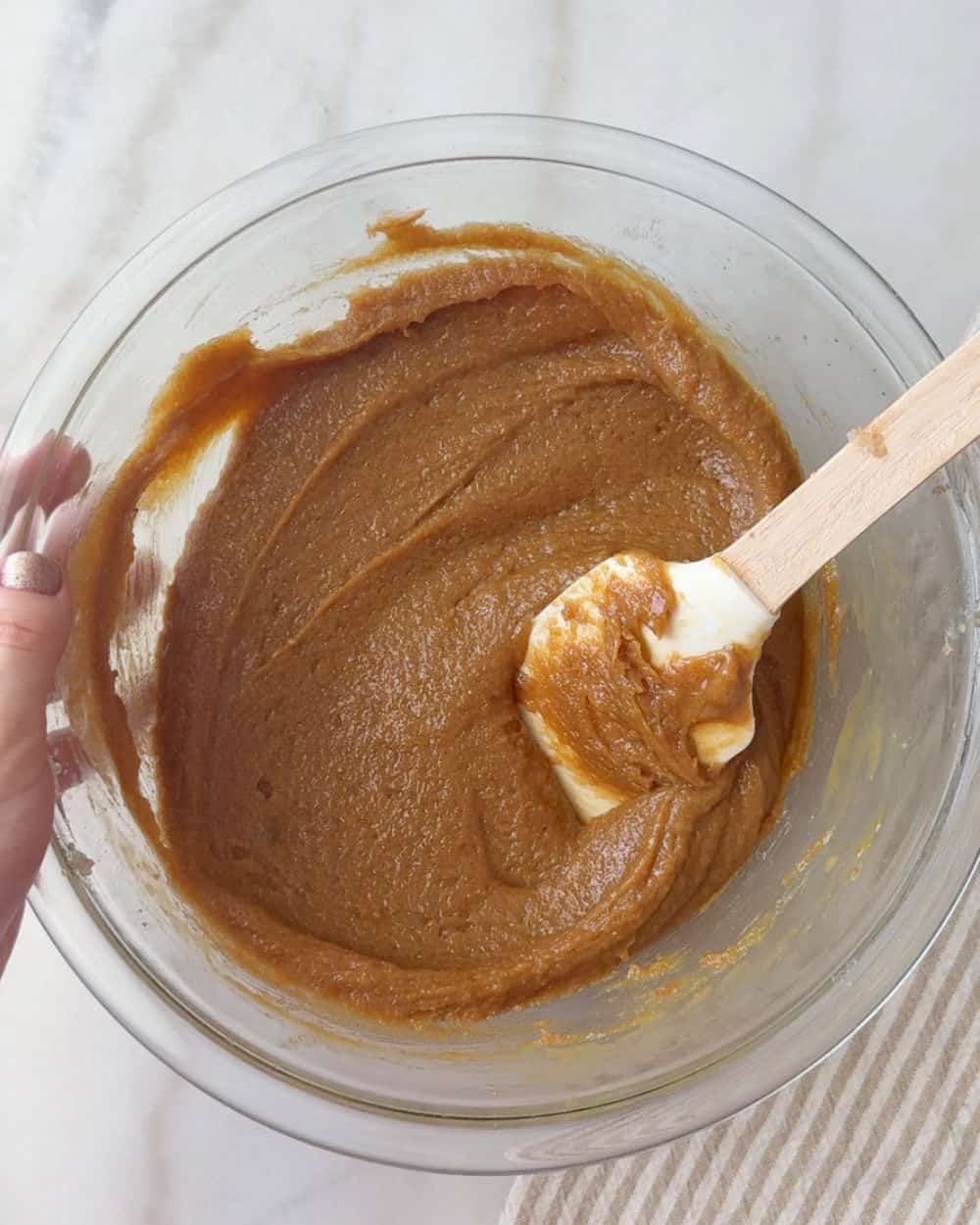 stirring wet ingredients in mixing bowl.