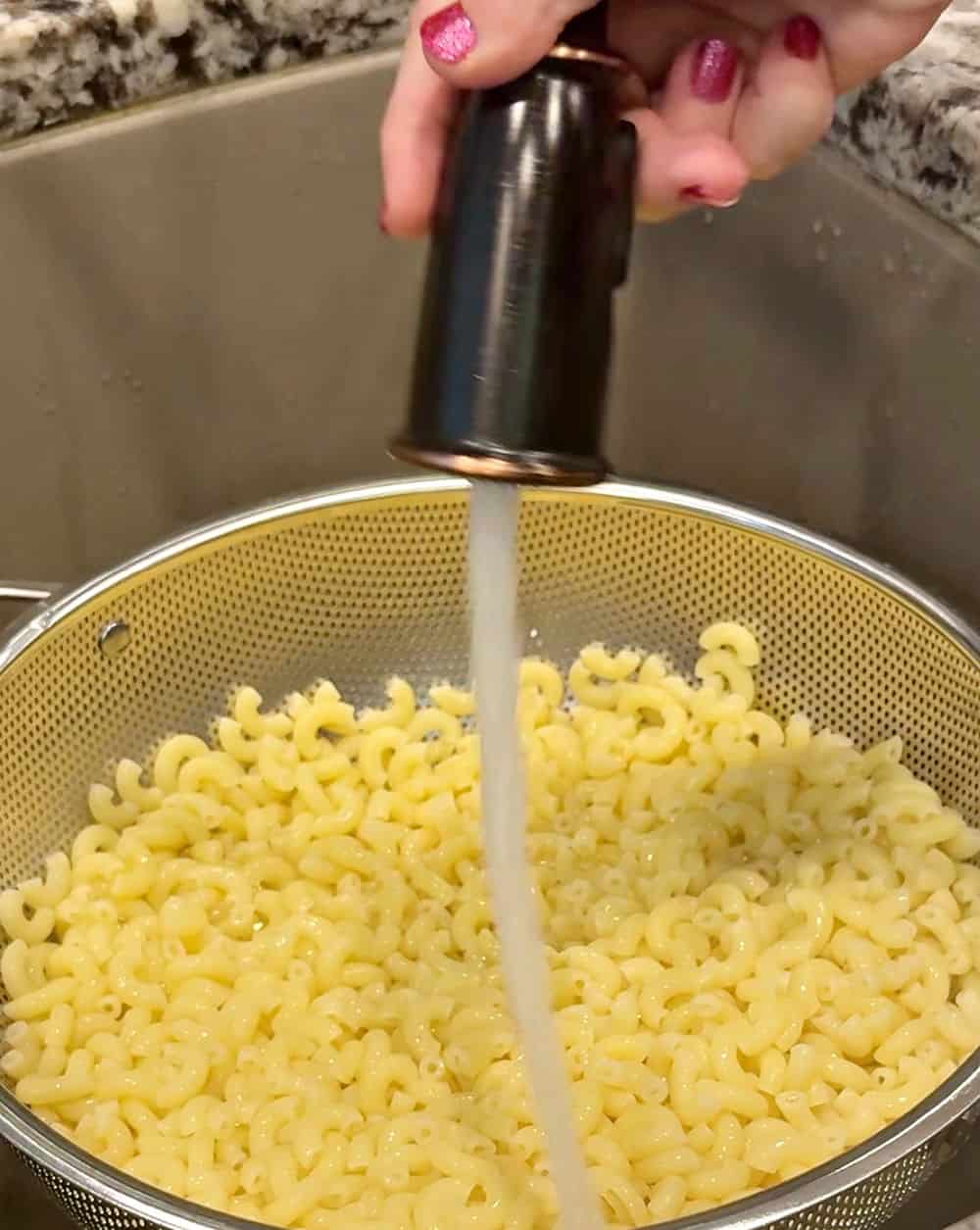 rinsing macaroni in colander.