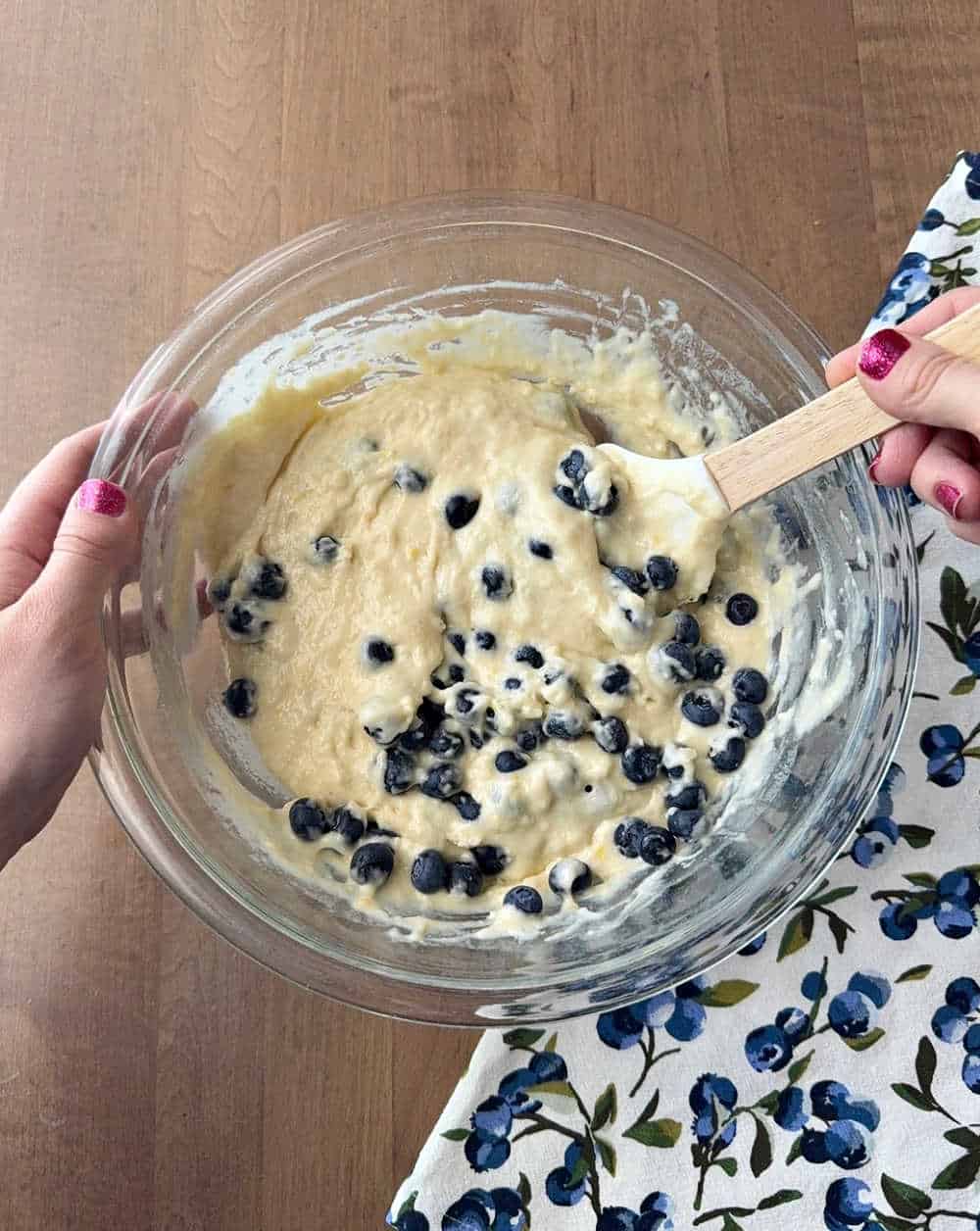 folding in blueberries with spatula.