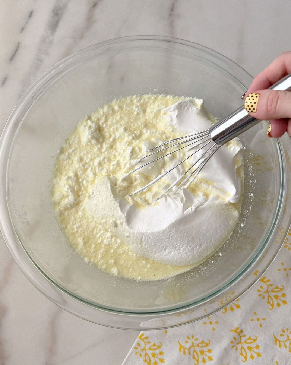 adding whipped topping to mixture.