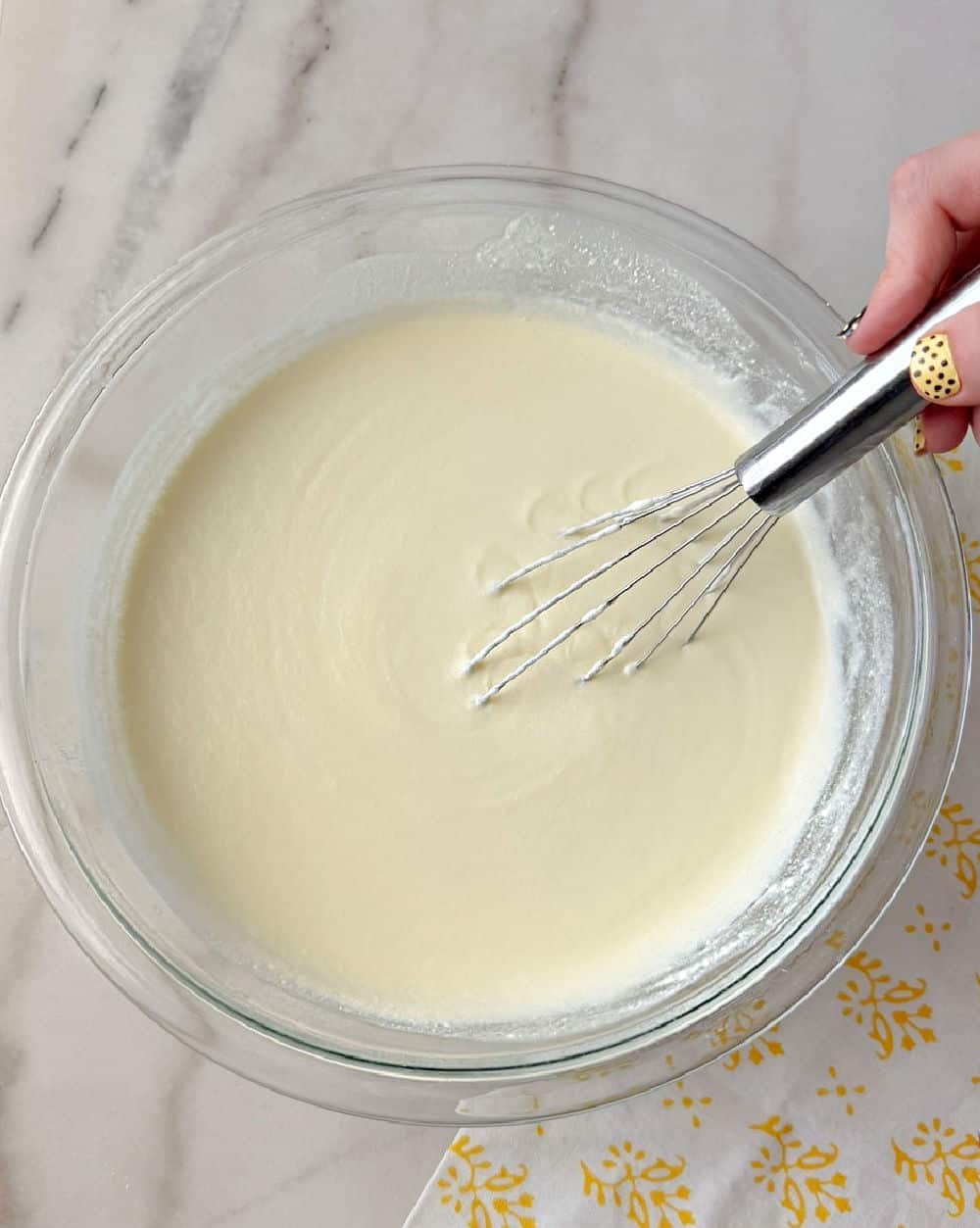 whisking pie filling in glass bowl.