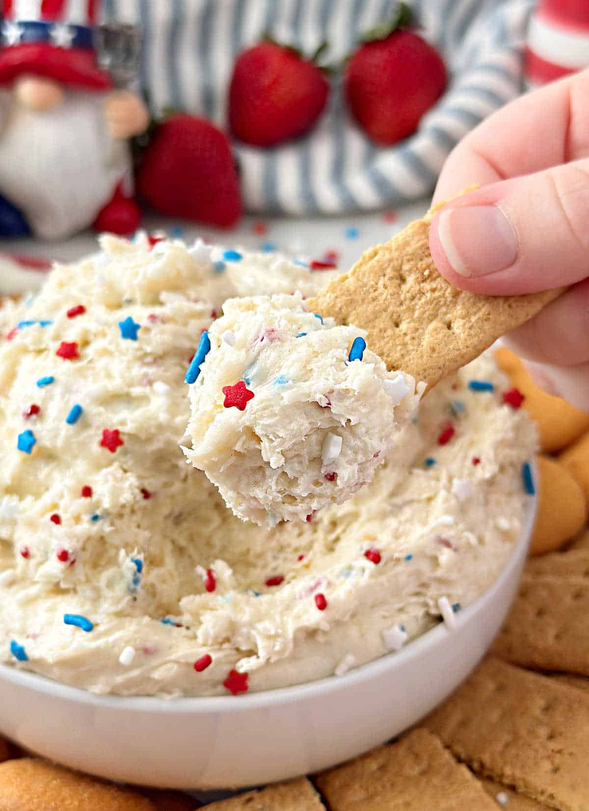 red, white and blue funfetti dip on graham cracker.