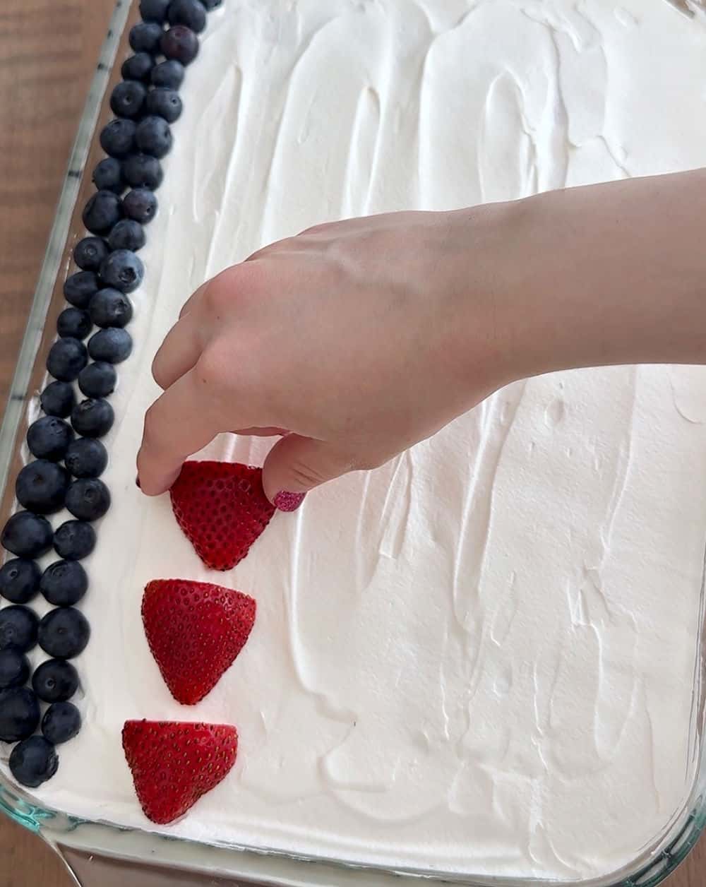 adding strawberries and blueberries.
