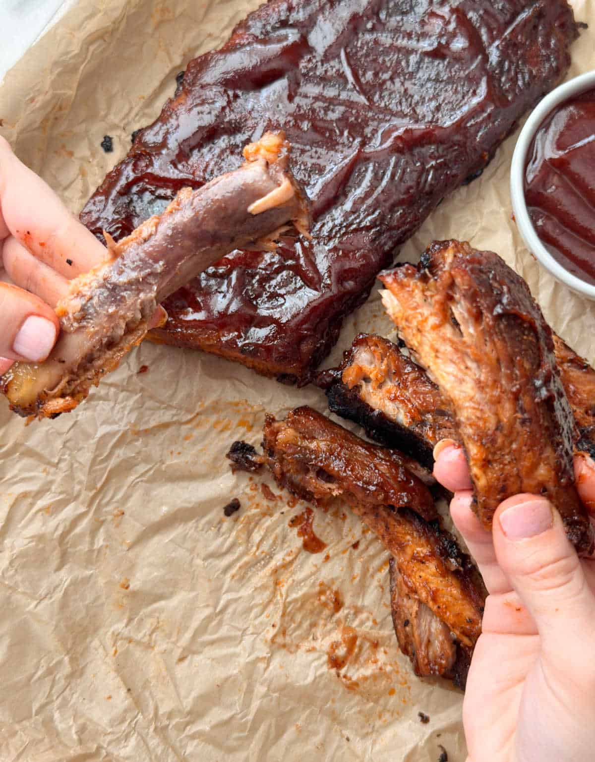fall off the bone baked pork ribs in hand.