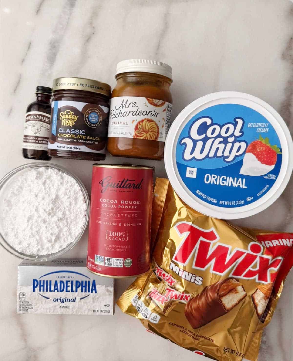 cool whip, cream cheese, Twix bars, cocoa, vanilla, sugar, toppings.