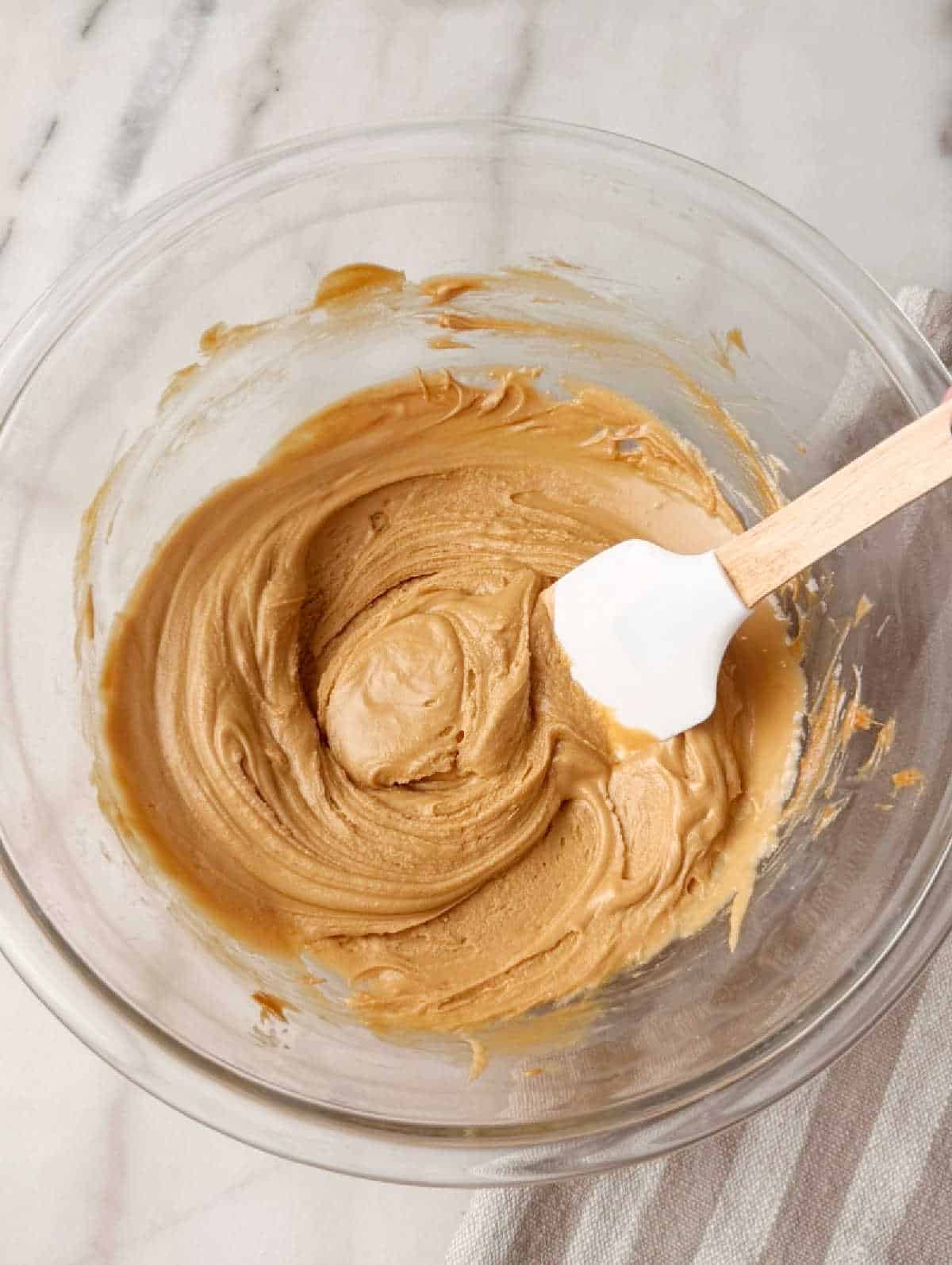 stirring cookie butter mixture with spatula.
