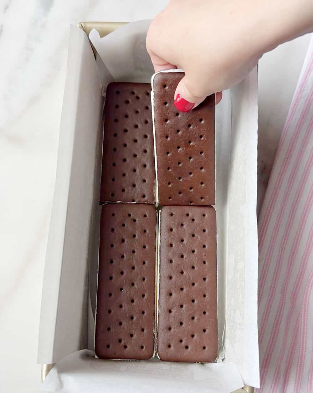 placing ice cream sandwiches in loaf pan.