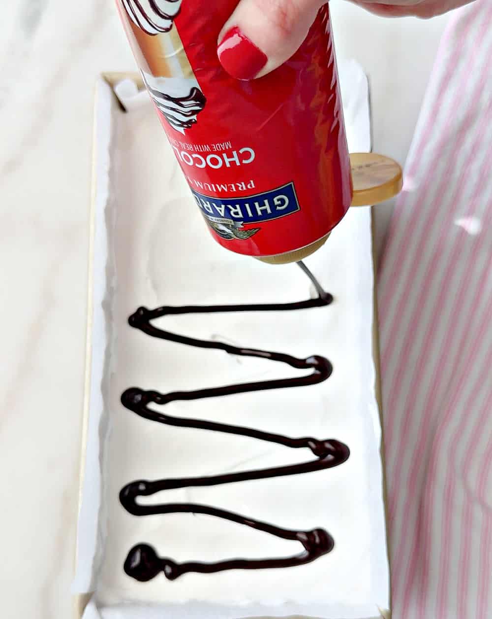 adding chocolate syrup.