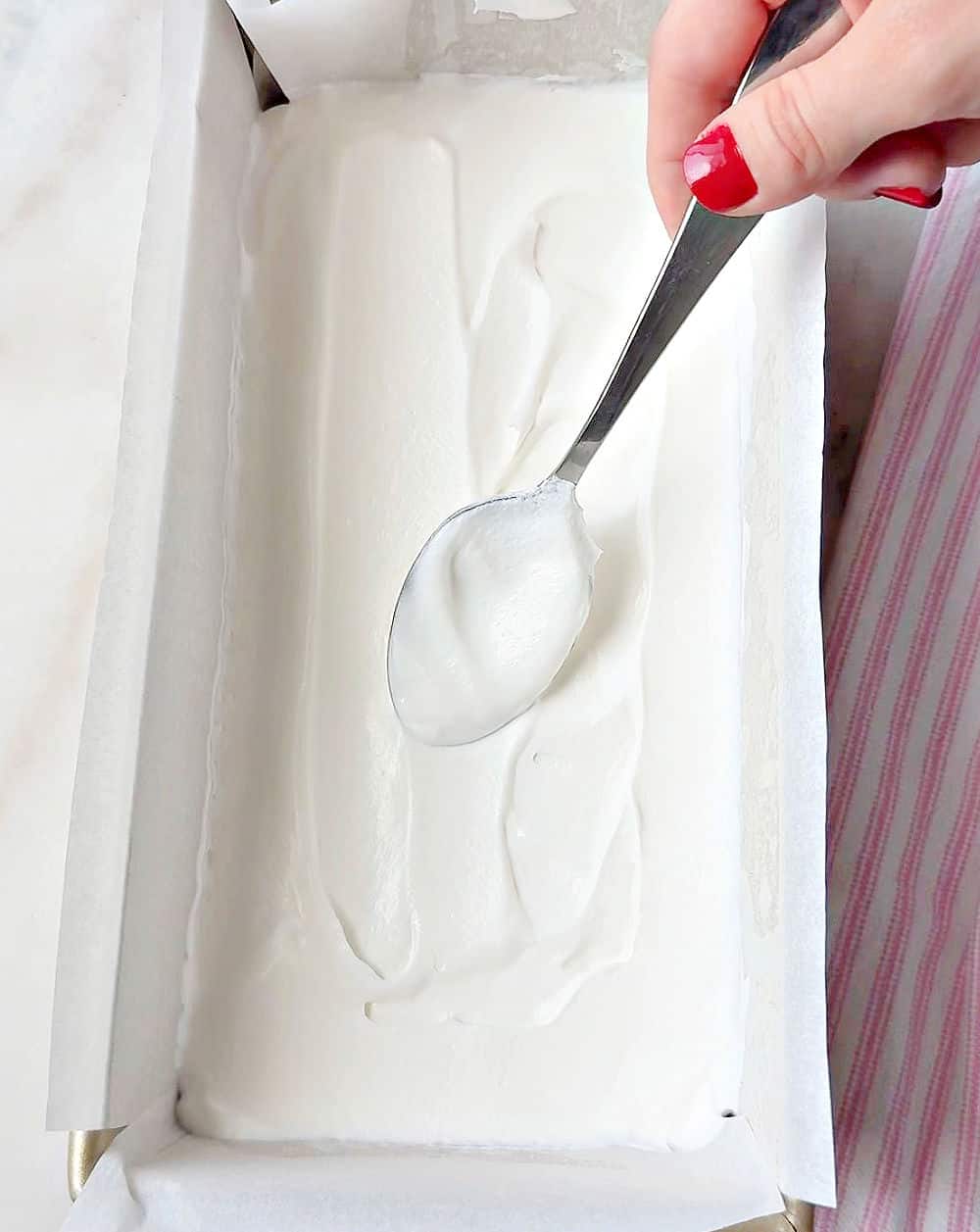 spreading cool whip on sandwich layer.