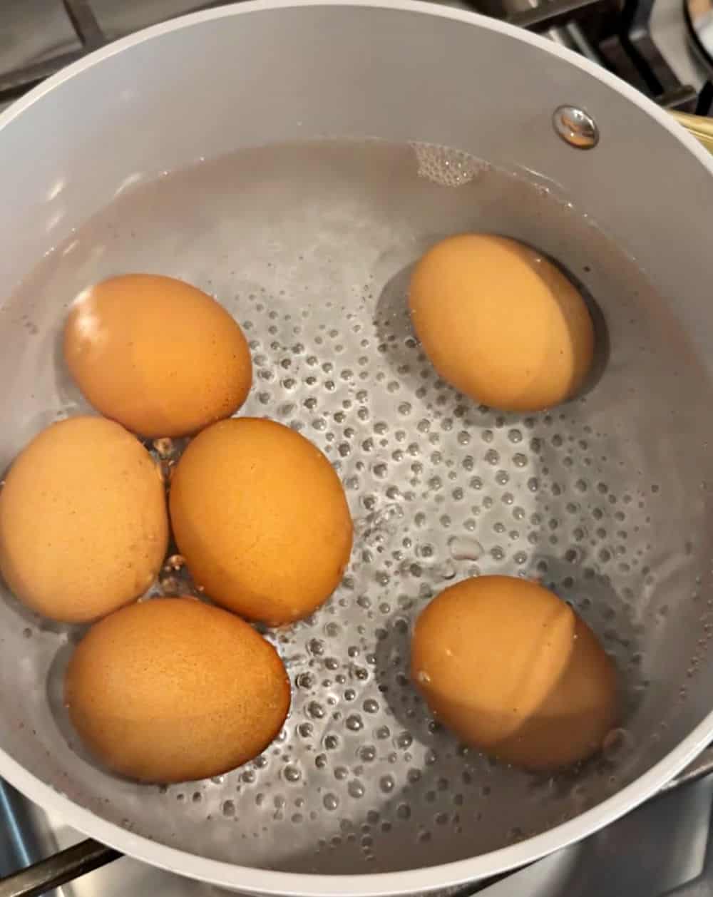 eggs simmering in water.