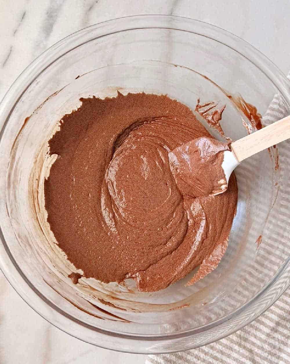 mixing chocolate mixture in glass bowl.
