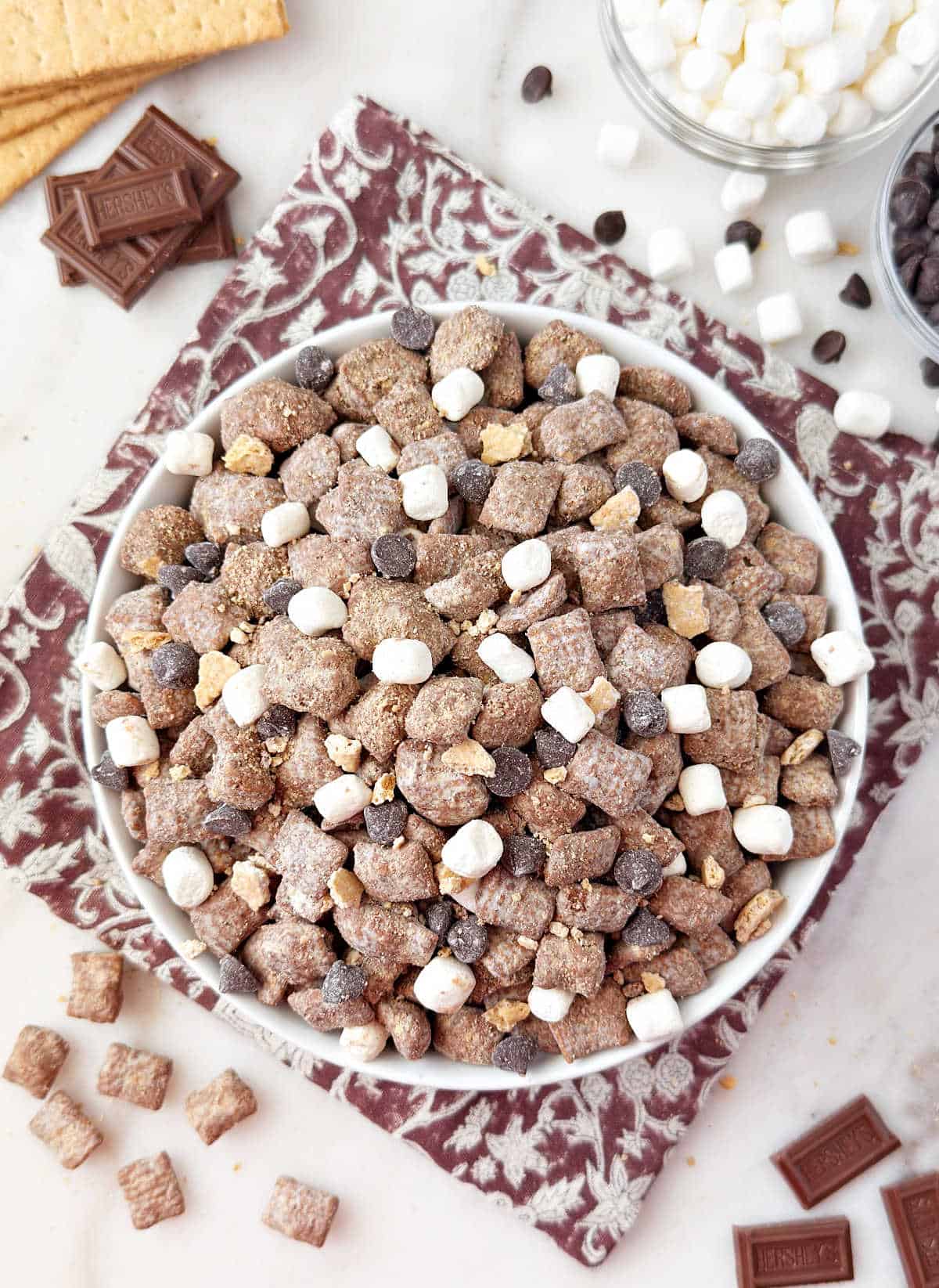 bowl of smores puppy chow with marshmallows and chocolate.