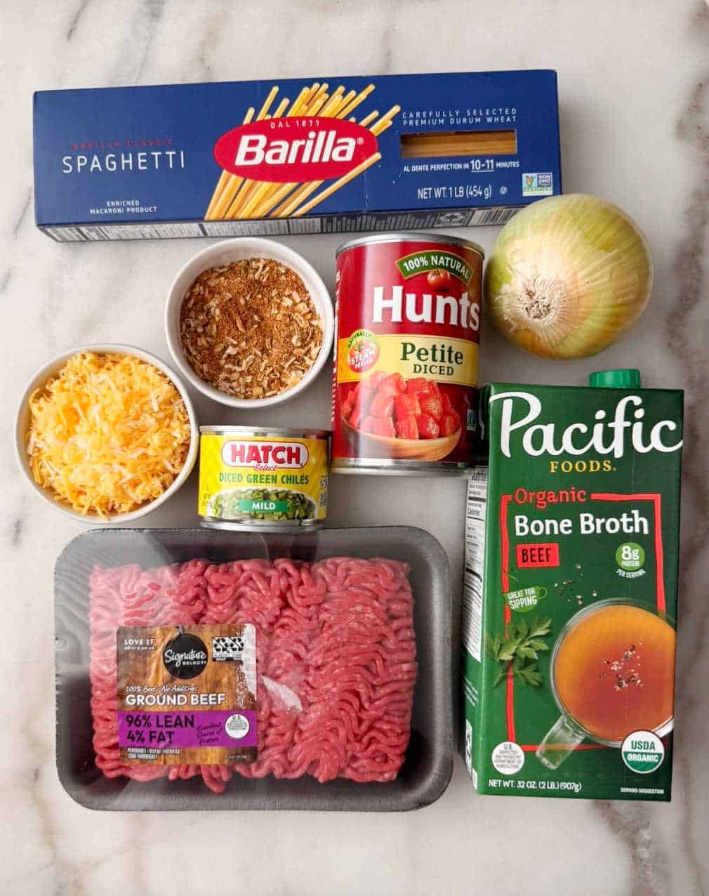 spaghetti noodles, ground beef, seasoning, cheese, chiles, tomatoes, onion, broth.