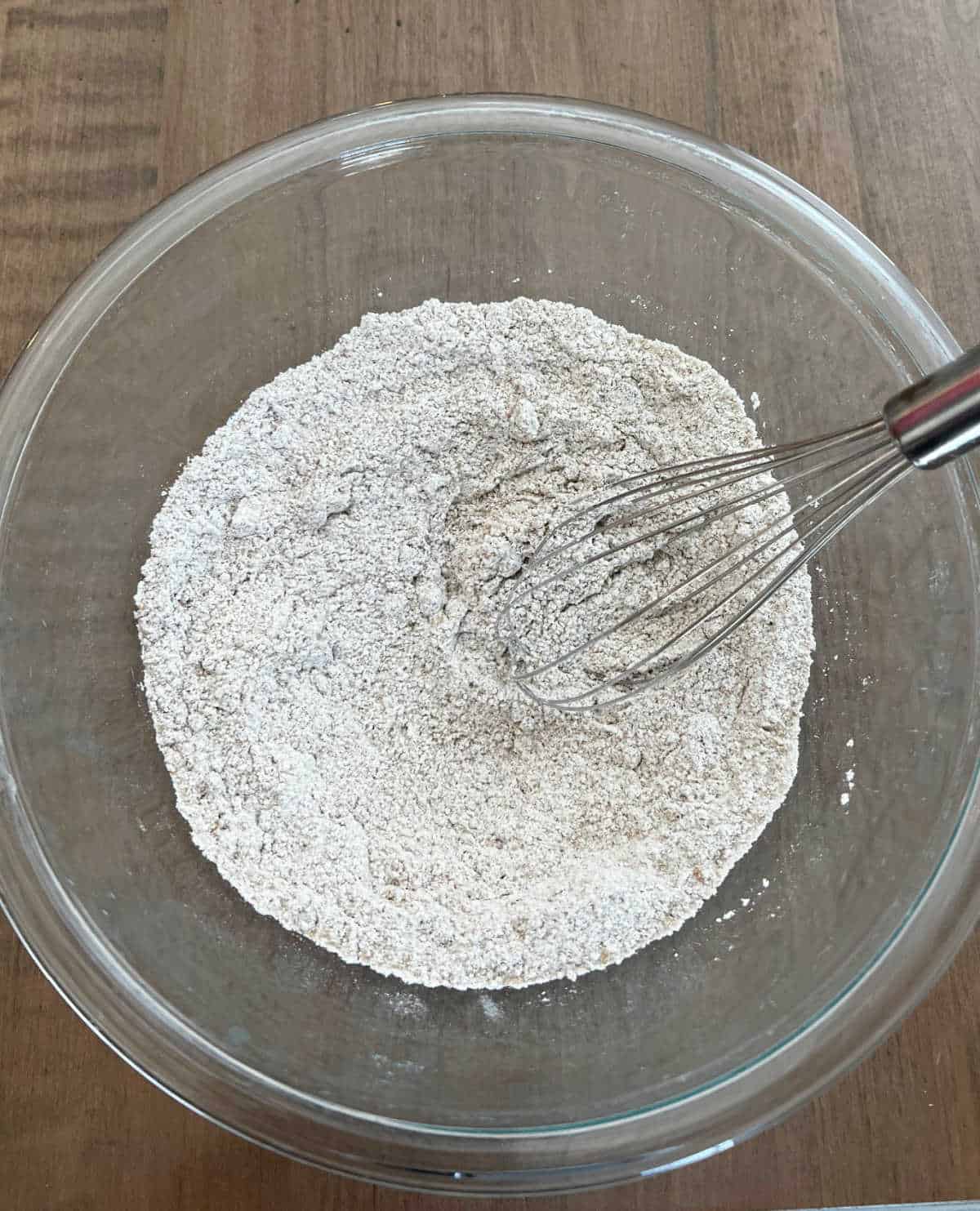 whisking dry ingredients in mixing bowl.