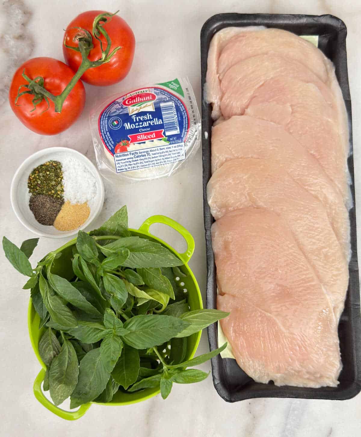 chicken breasts, tomatoes, fresh mozzarella, spices and basil.