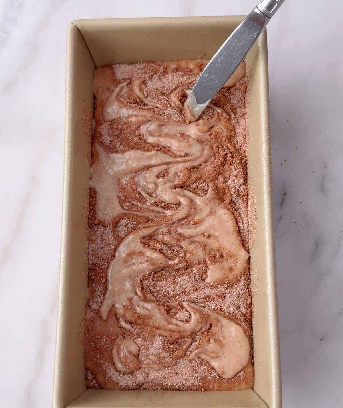 swirling cinnamon mixture with knife.