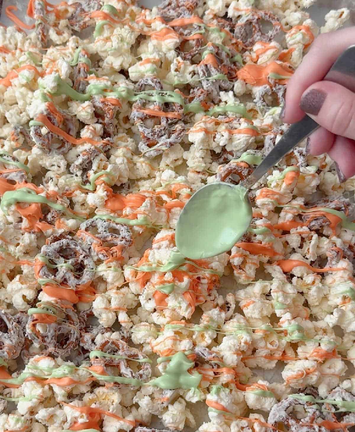 drizzling candy coating over snack mix.