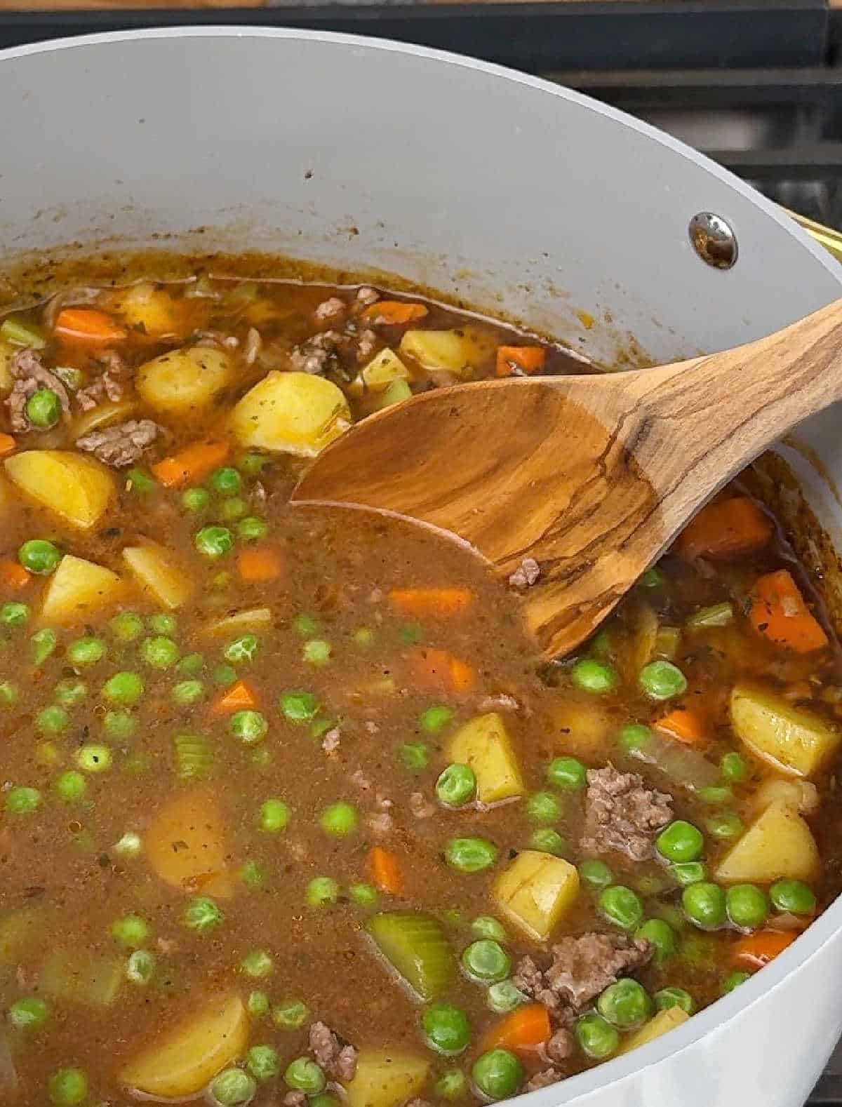 stirring in frozen peas.