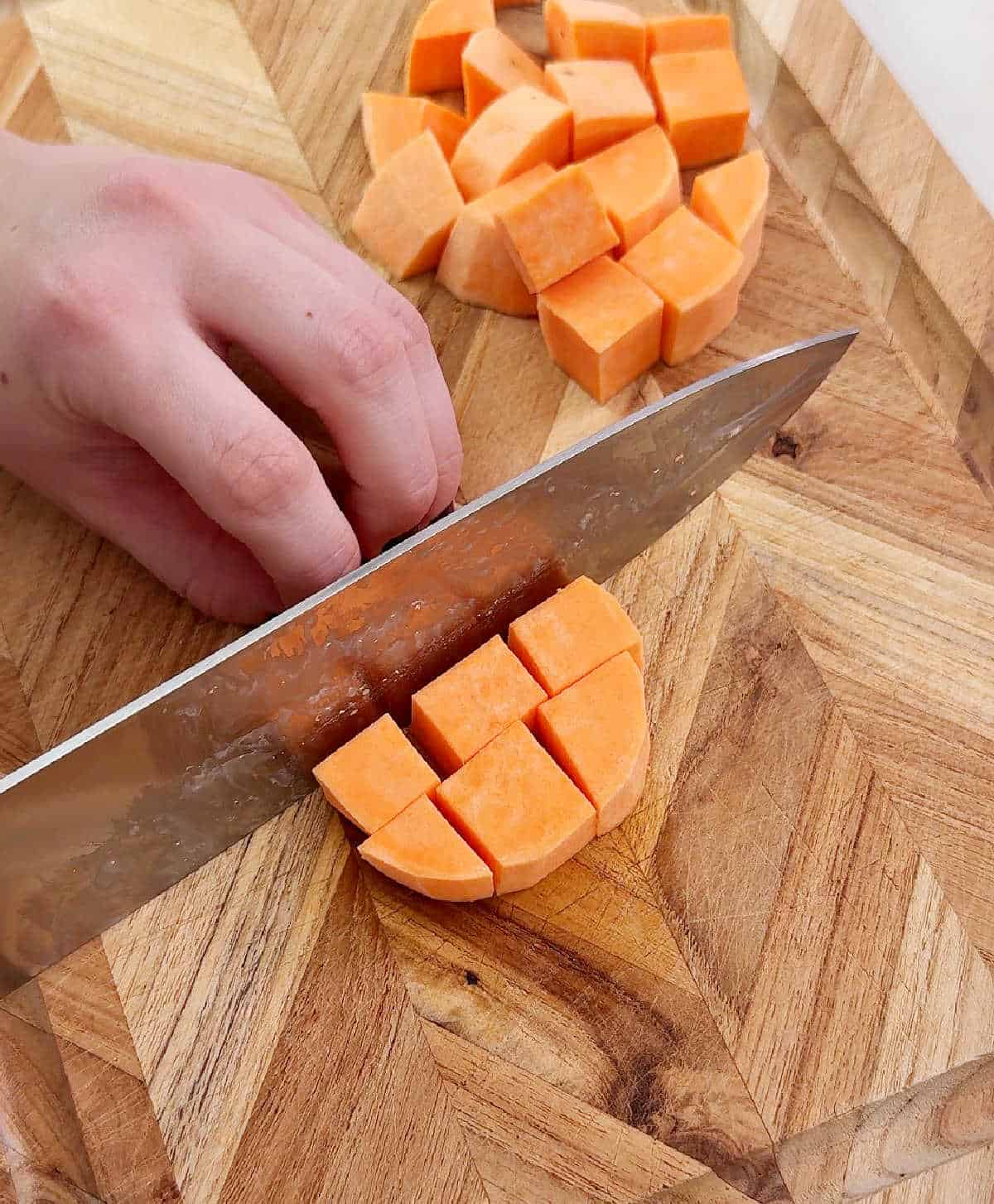 slicing sweet potato rounds into cubes.