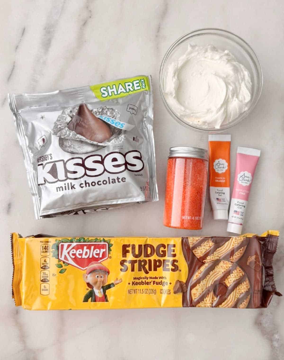 Fudge stripes, hershey's kisses, icing, sprinkles.