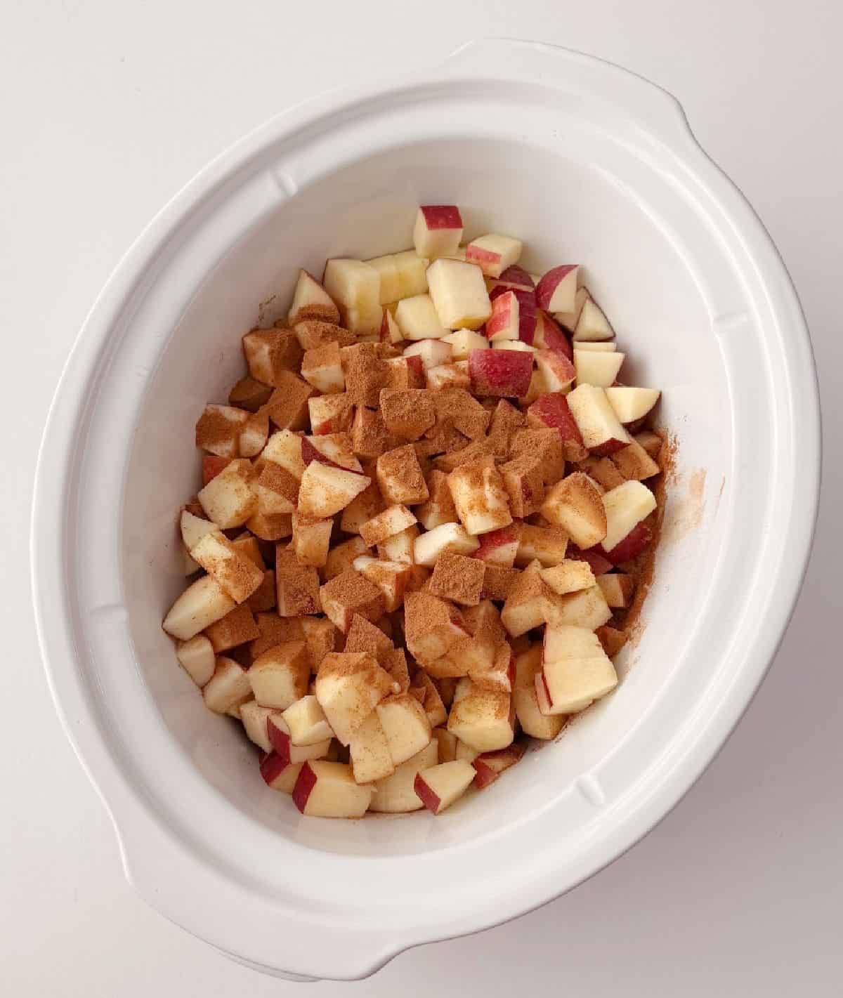 cut apples and cinnamon in crockpot.
