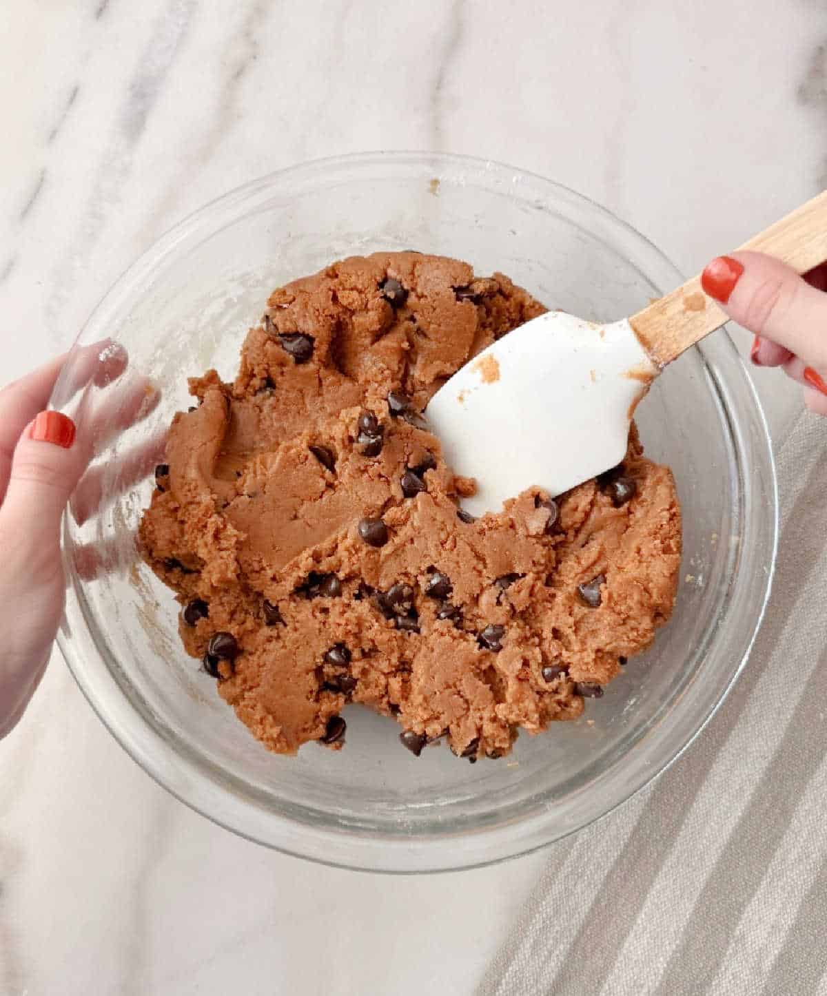 adding chocolate chips and cookies with spatula.