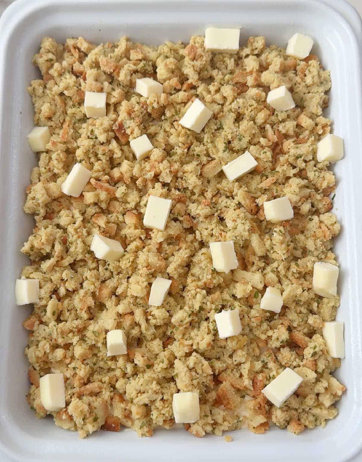 cubes of butter on top of stuffing layer.