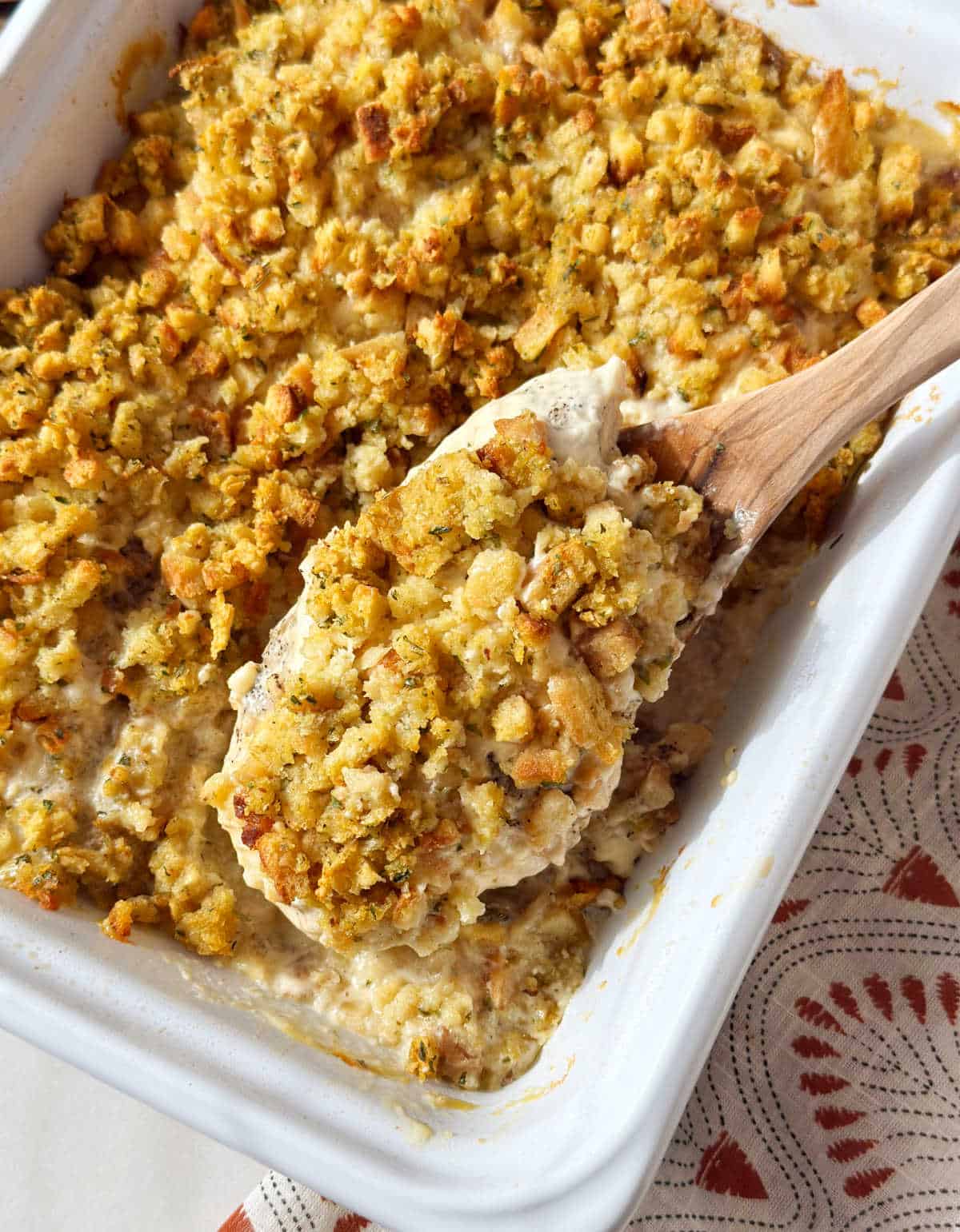 baked chicken breasts and stove top stuffing on wooden spoon.