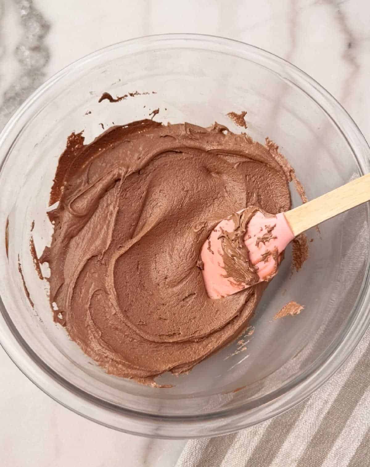 stirring melted butter with peanut butter, chocolate and marshmallow creme.