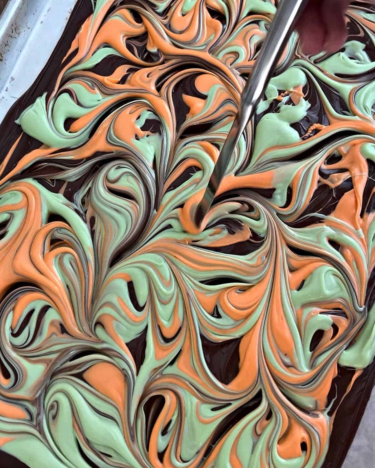 swirling candy coating into chocolate layer.