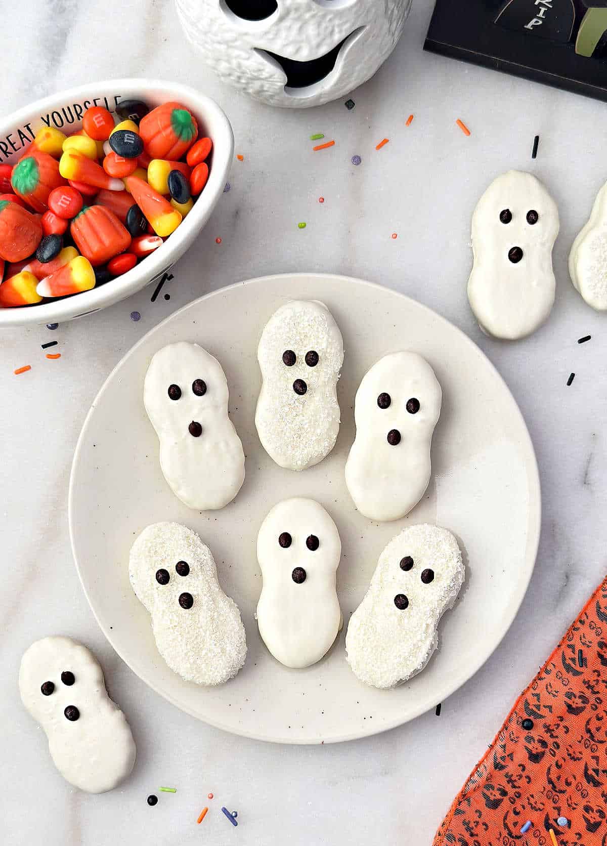 nutter butter ghost cookies on a plate.