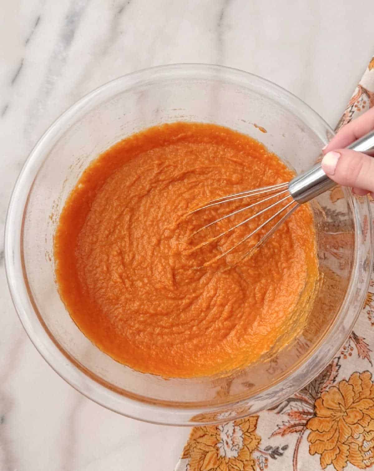 whisking in pumpkin puree.