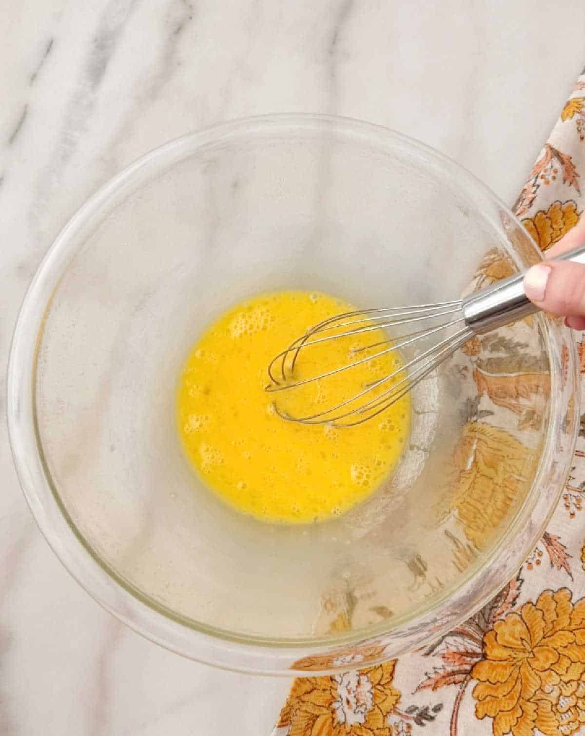 whisking eggs in mixing bowl.