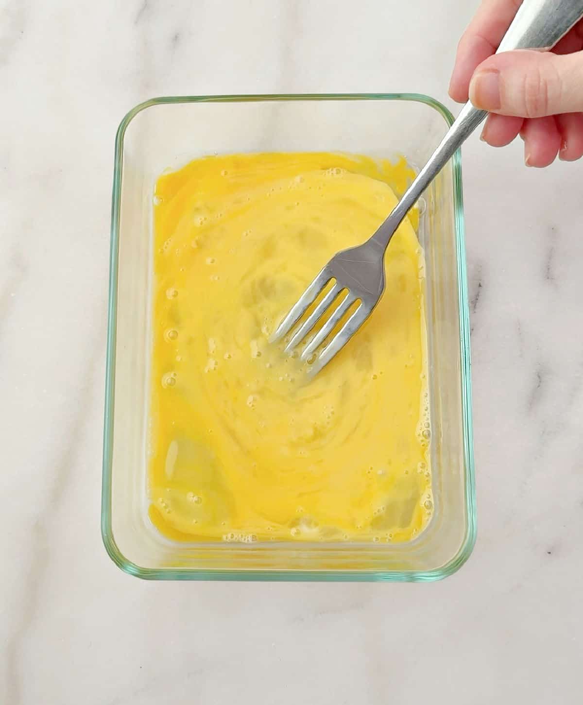 whisking eggs with fork.