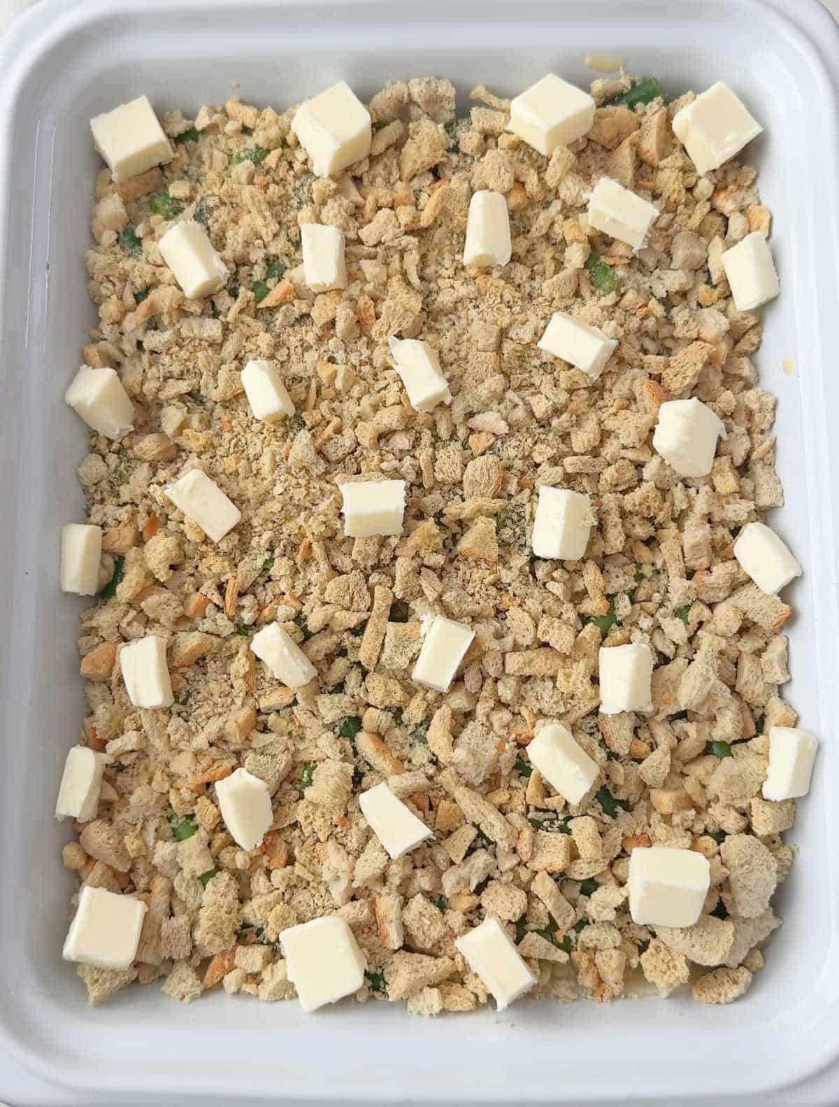 cubes of butter on top of stuffing layer.
